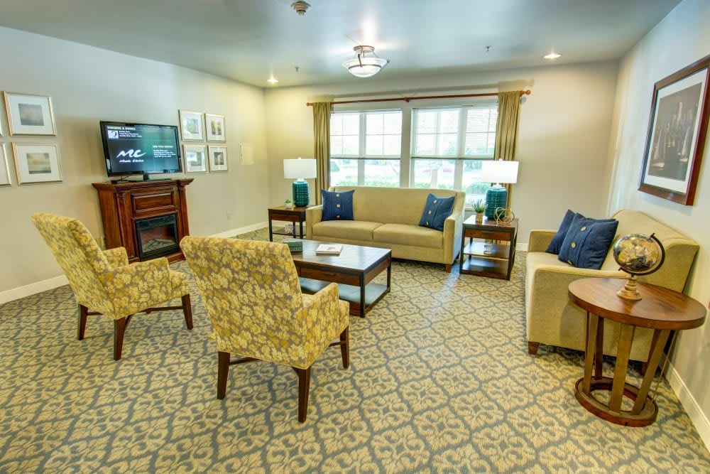 A cozy and well-decorated living room featuring comfortable seating, a television, and elegant lighting.