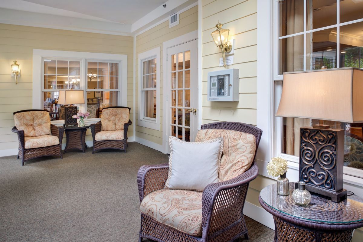 A cozy living room with wicker chairs, soft lighting, and warm decor.