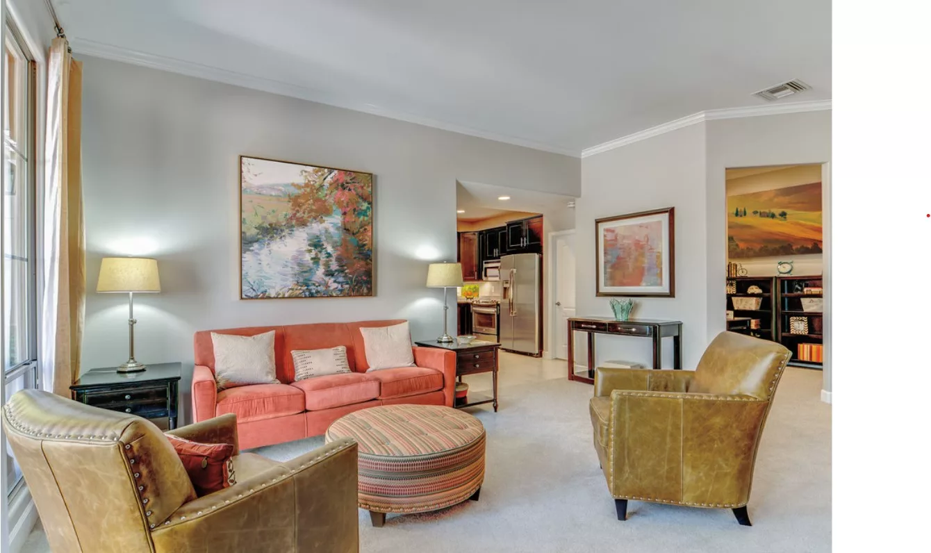 A cozy living room with colorful furniture and decorative artwork.