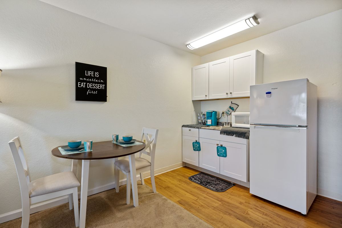 A compact kitchen and dining area in a modern apartment.