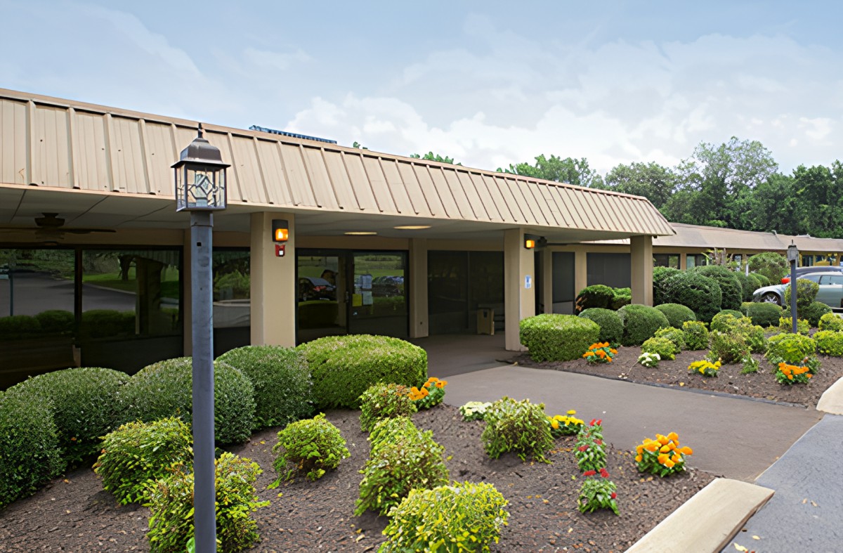 A well-maintained building exterior with landscaped gardens and shrubs.