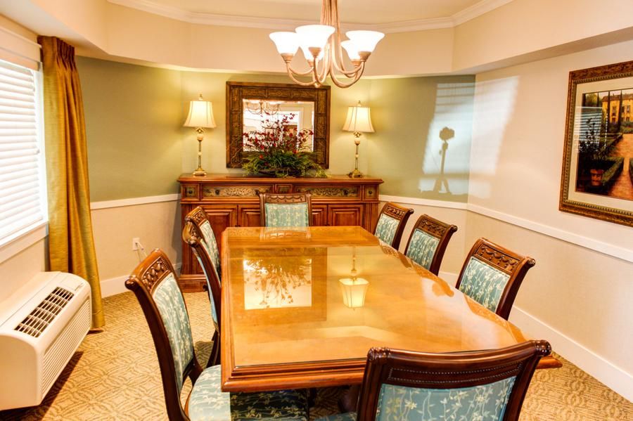 Elegant dining room with a wooden table and upholstered chairs.