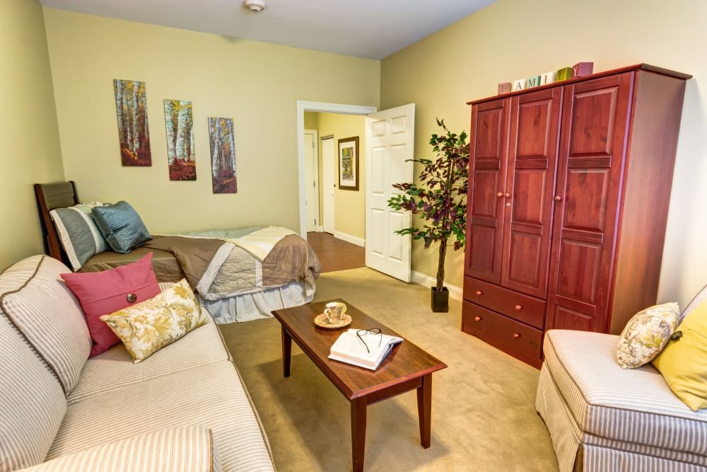 A cozy living area with a sofa, bed, and coffee table.