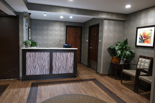 A modern reception area featuring a sleek front desk and comfortable seating.