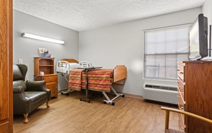 A hospital room featuring a patient bed and medical equipment.