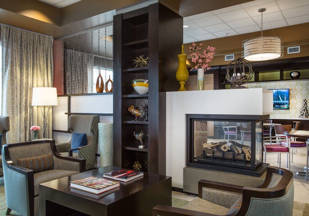 A cozy living room interior with a modern fireplace and stylish decor.
