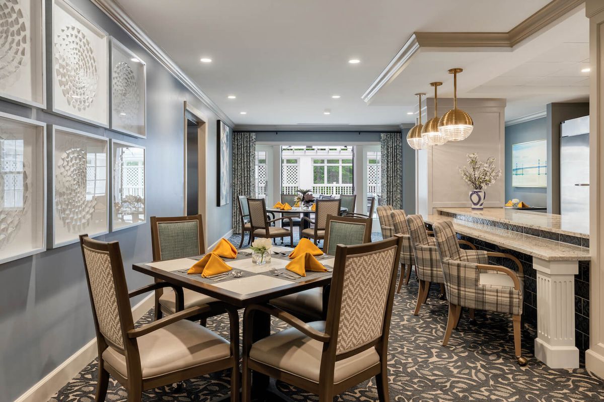 A modern dining room with elegant furnishings and a well-arranged table setting.