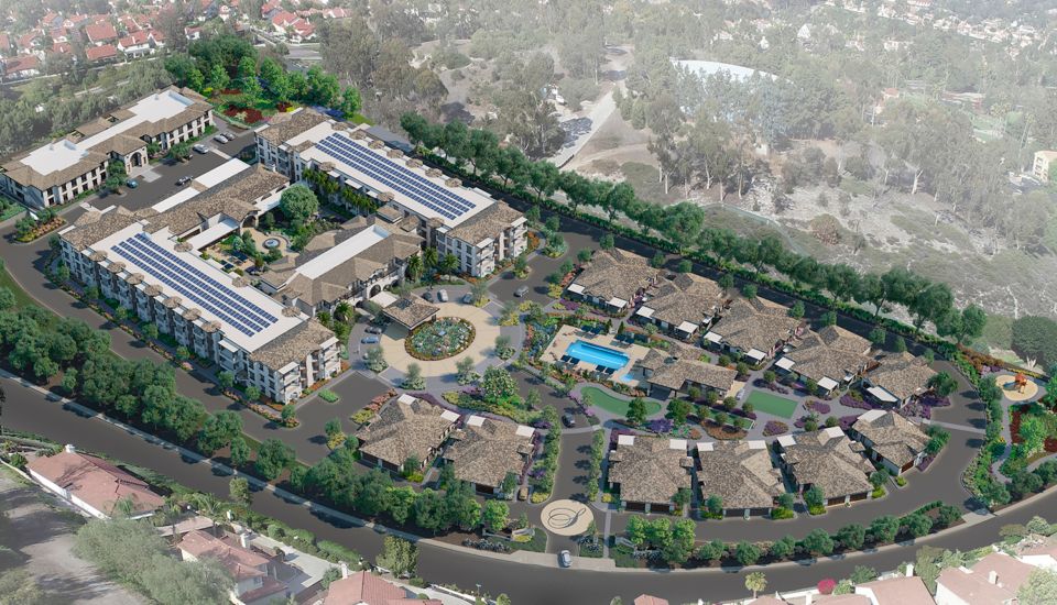 Aerial view of a residential housing complex featuring solar panels, a swimming pool, and landscaped areas.