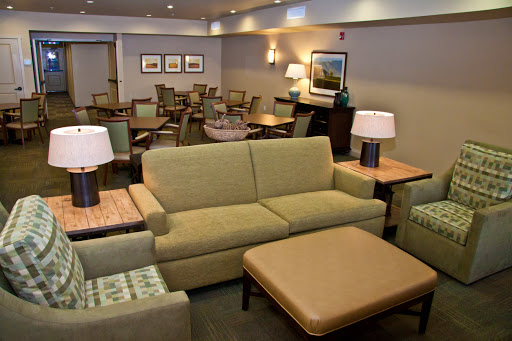 A cozy lounge area featuring comfortable seating and warm lighting, perfect for relaxation.