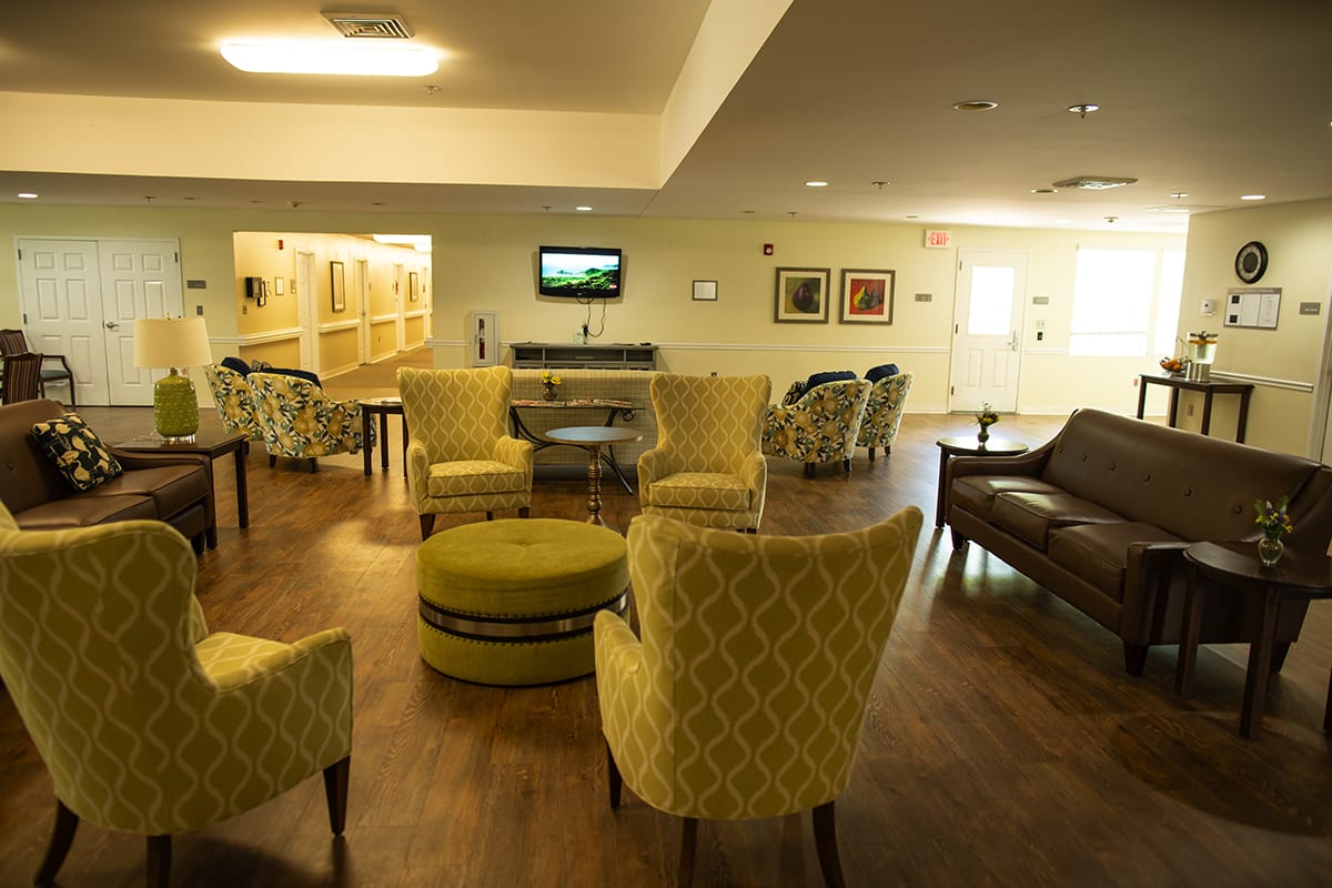A cozy lounge area with comfortable seating and a television.