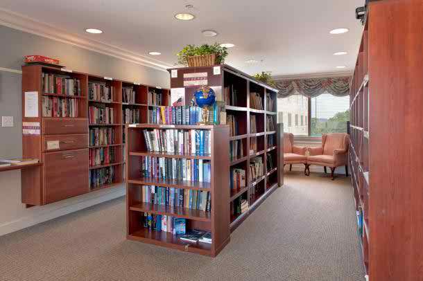 A cozy library interior with rows of bookshelves and a reading area.