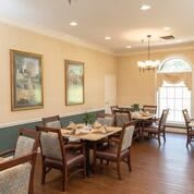 A cozy dining room with elegant furniture and decor.