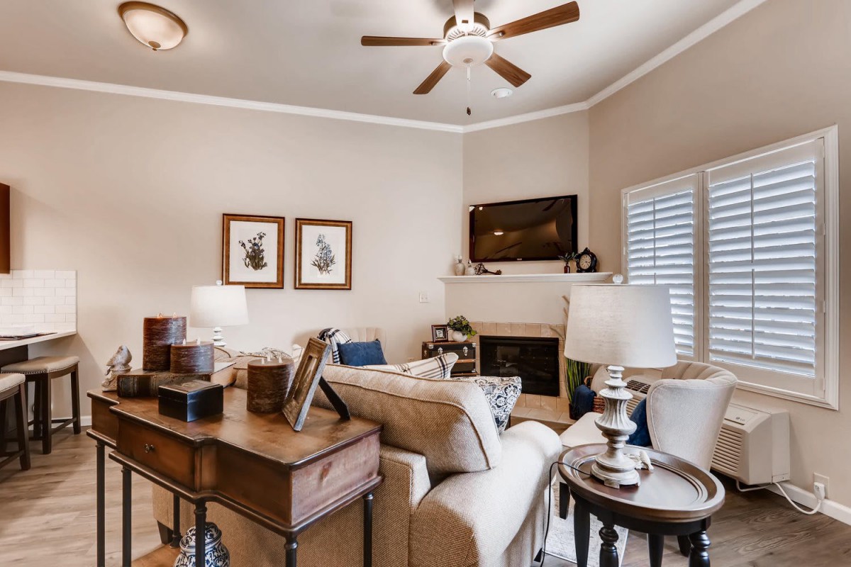 A cozy living room with comfortable seating, warm lighting, and tasteful decor.
