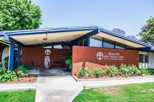 The exterior view of a community center showcasing modern architectural design and well-maintained landscaping.
