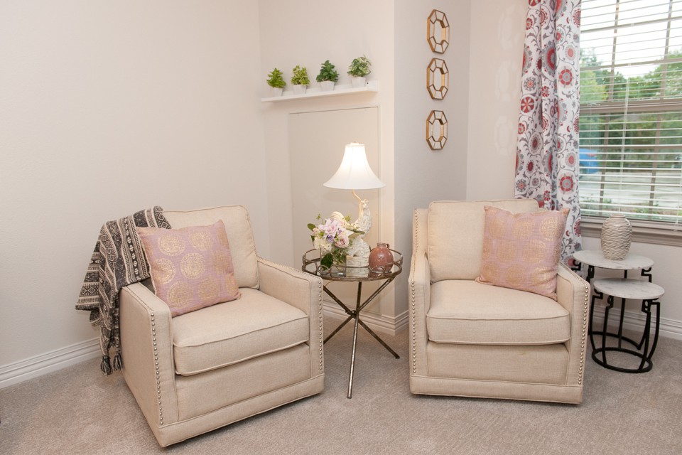Cozy living room corner with two armchairs, a side table, and decorative accents.