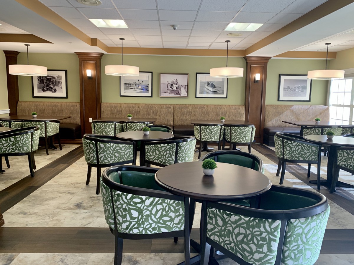 A stylish and cozy dining area with neatly arranged tables and chairs.