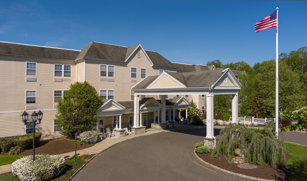 A grand building entrance with columns and a circular driveway.