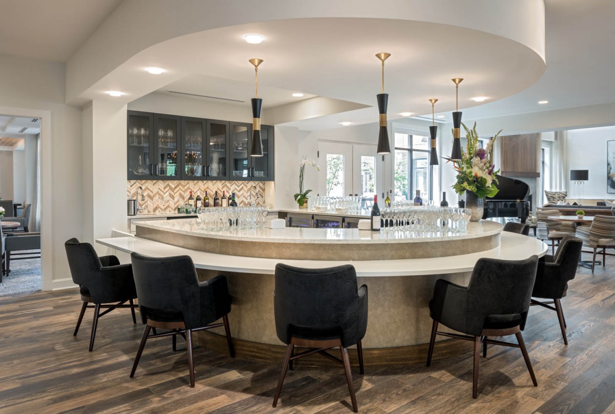 Modern kitchen with a circular bar and stylish seating.