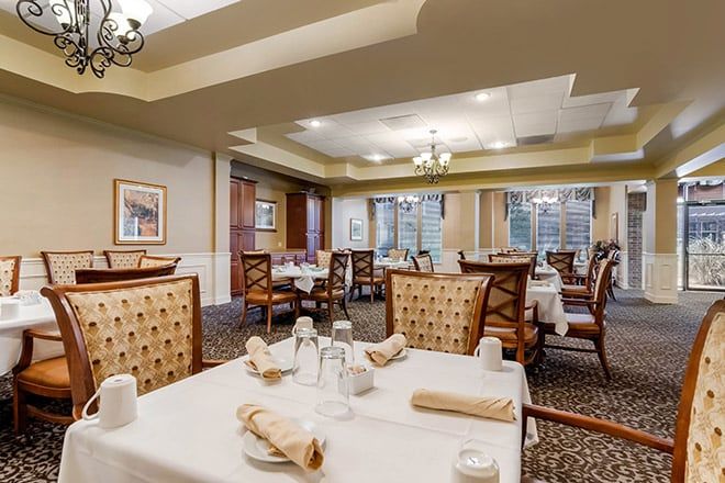 Elegant dining room with neatly arranged tables and chairs.