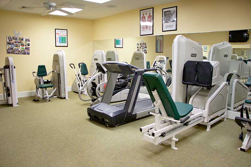 A fitness center equipped with a variety of exercise machines, including treadmills and strength-training equipment.