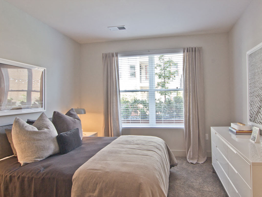 A cozy bedroom with soft, neutral colors and stylish decor.