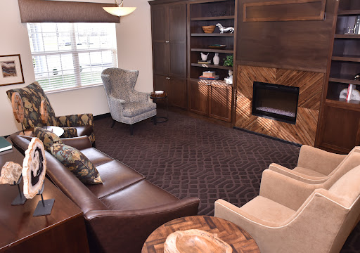 A cozy and elegantly designed living room featuring comfortable seating, wooden accents, and a fireplace.