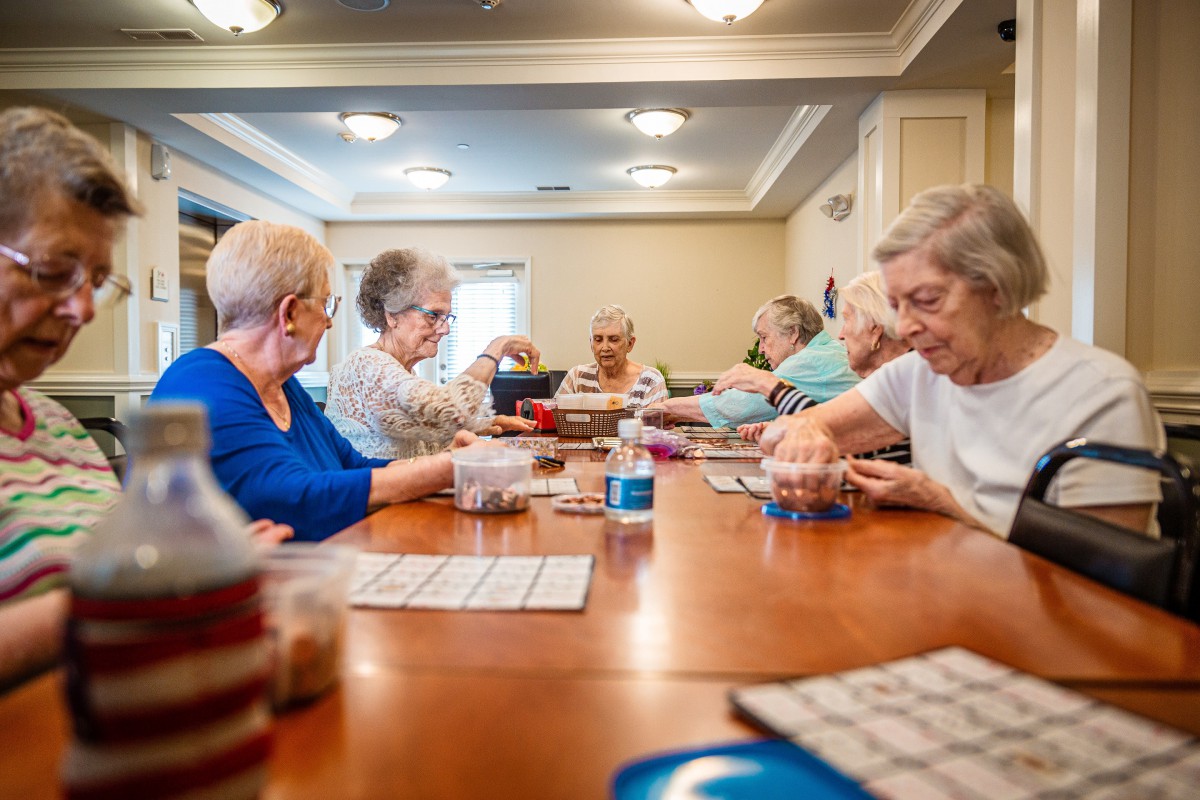 A group of seniors enjoying a game of bingo together in a community setting.