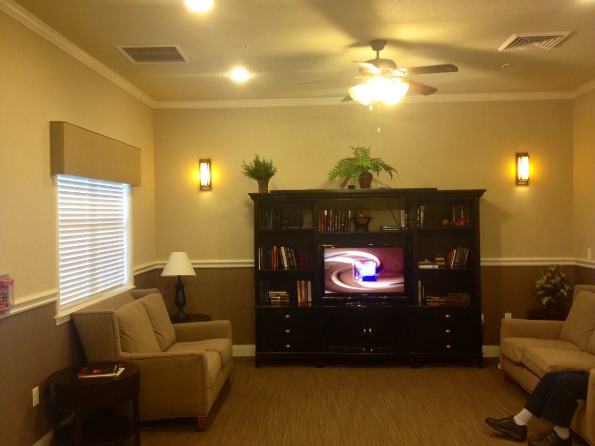 A cozy living room with a television and comfortable seating.