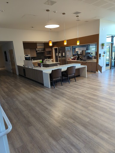 A modern kitchen and dining area with sleek design and open space.