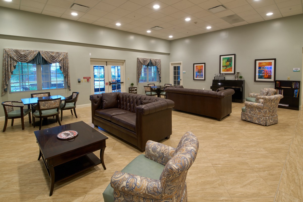 A spacious and well-decorated lounge area with comfortable seating and modern decor.