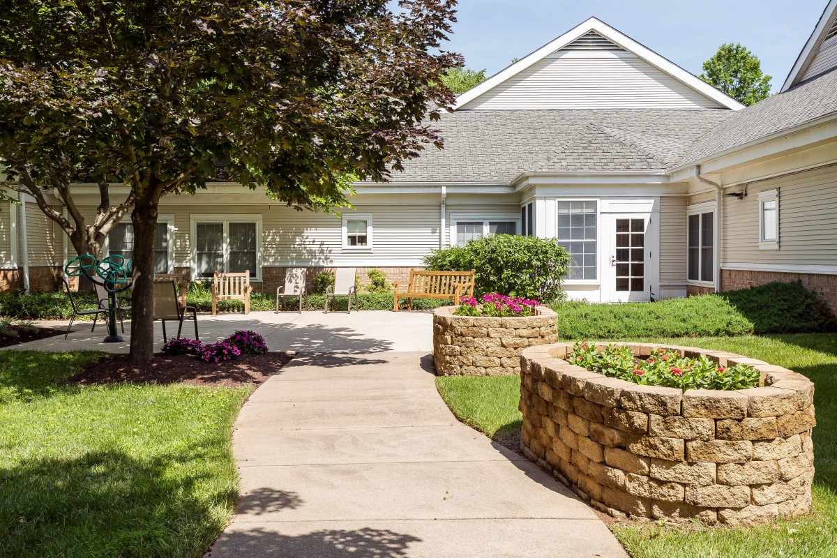A charming house with a landscaped garden and pathway.