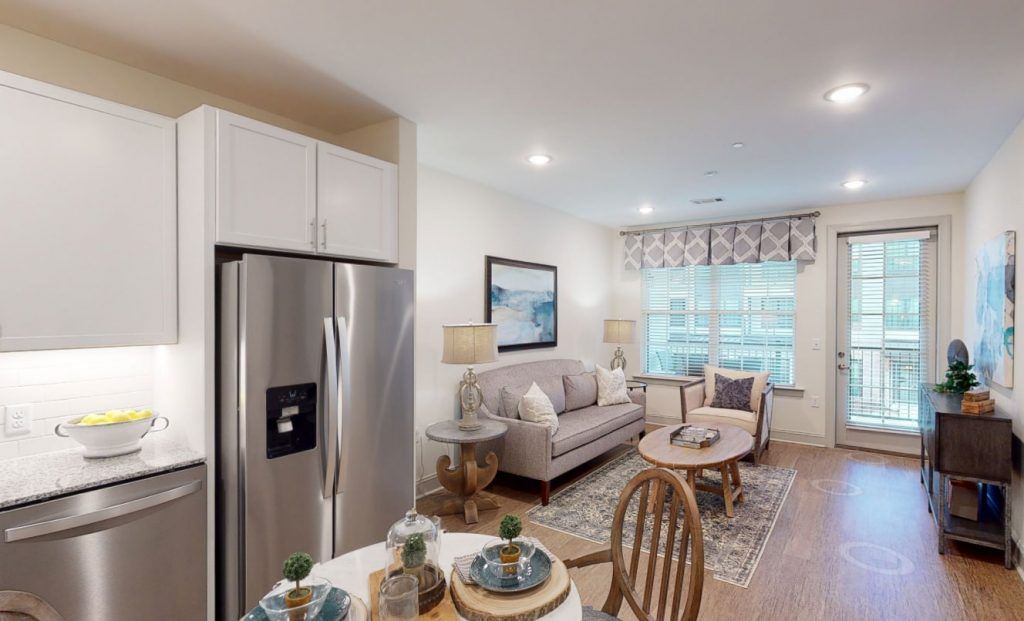 A cozy open-plan living area featuring a modern kitchen and comfortable seating.