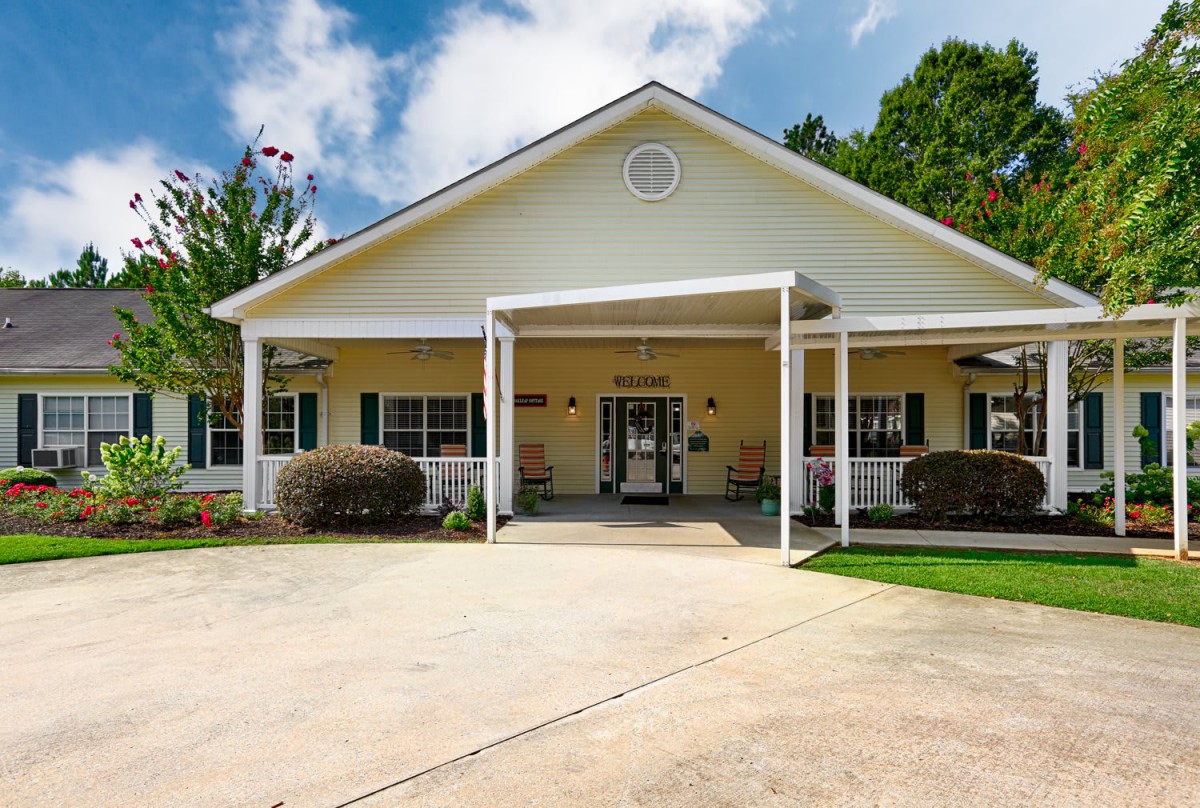 A suburban residential building with a driveway and porch.