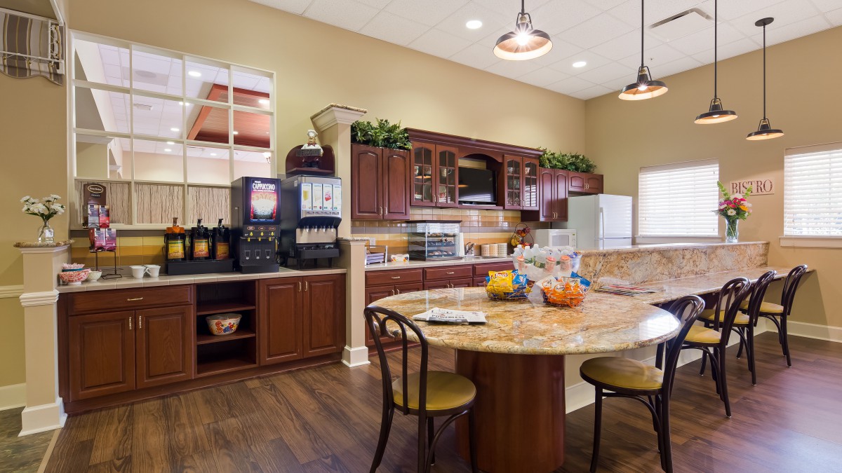 Spacious kitchen area with wooden cabinets and a large dining table.