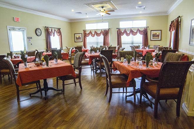 A beautifully decorated dining room with tables set for a meal.