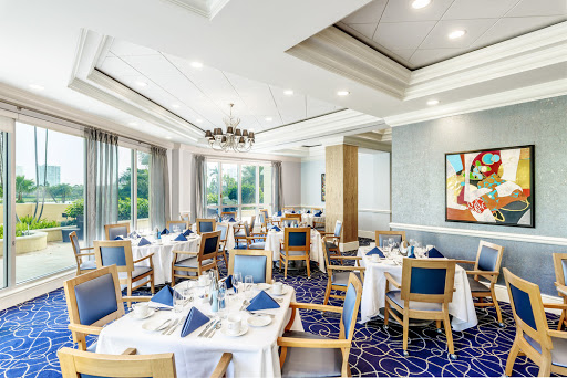 An elegantly arranged dining room featuring modern decor and a serene view.