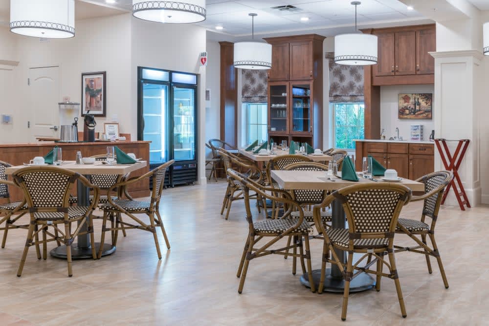 An elegantly designed dining area with neatly arranged tables and chairs.