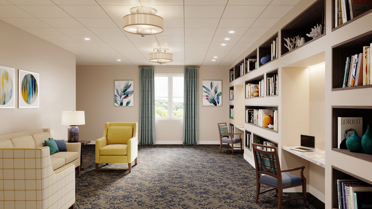 A cozy living room with bookshelves and a reading area.