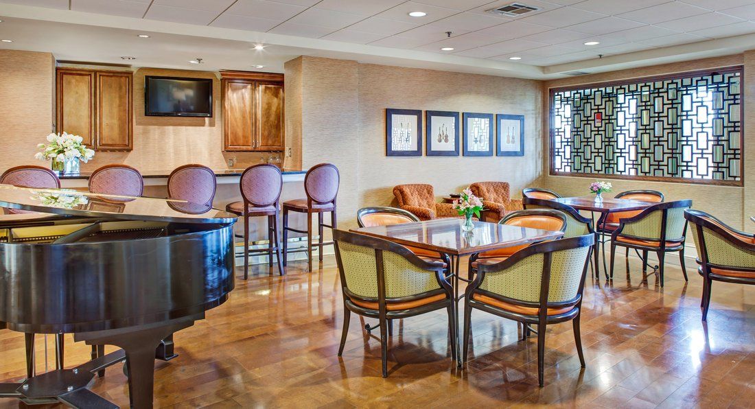 A cozy lounge area with a dining table, chairs, and a bar counter.