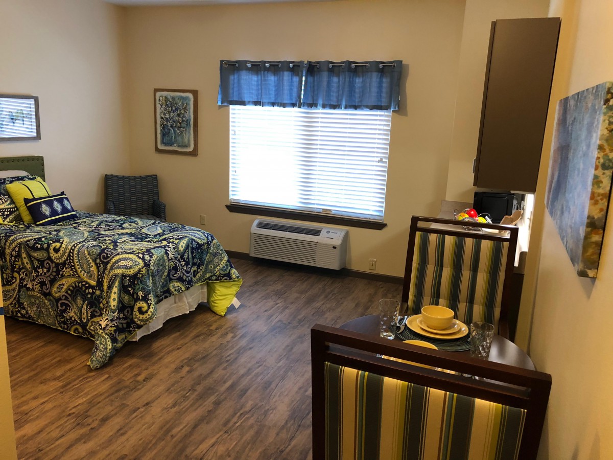 A cozy bedroom with a single bed and wooden flooring.