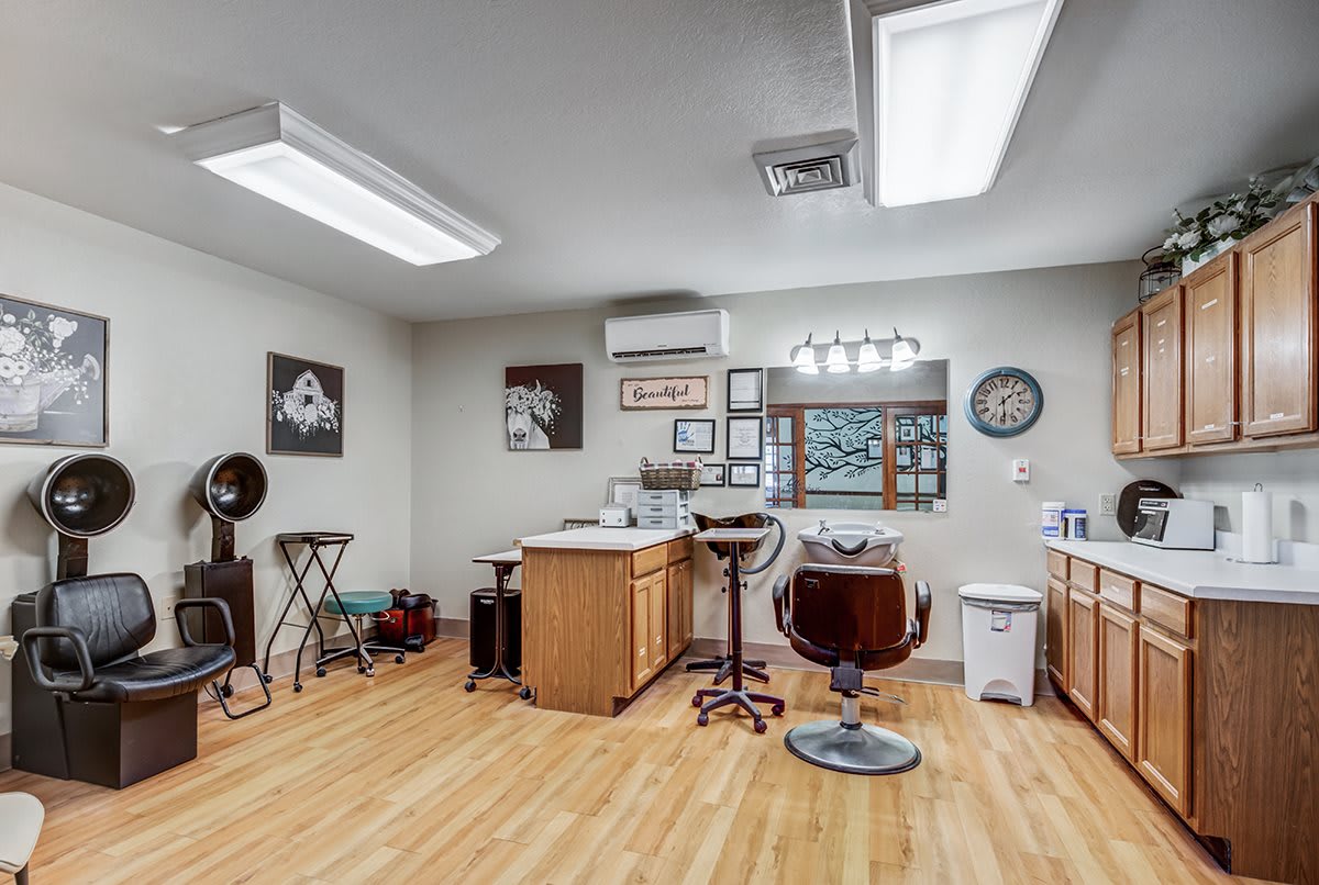 A well-equipped hair salon with chairs, mirrors, and styling tools.