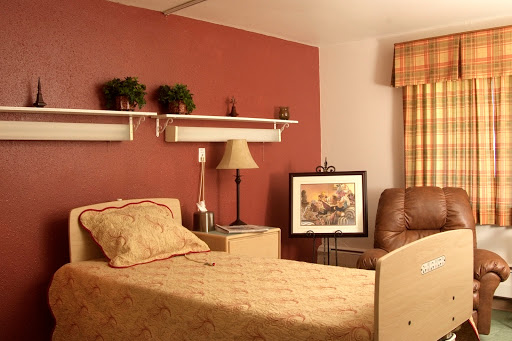 A cozy bedroom featuring warm tones, comfortable furniture, and decorative elements.