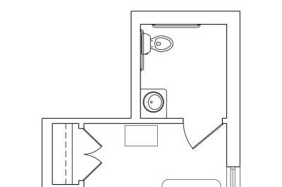 A floor plan section depicting a small bathroom with a toilet and sink.