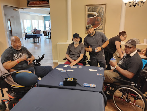 A group of friends enjoying a card game together in an indoor setting.