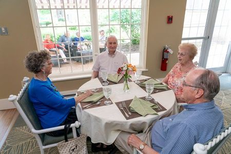 A group of seniors enjoying a meal together at a restaurant.
