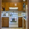 A cozy kitchen featuring wooden cabinets and standard appliances.