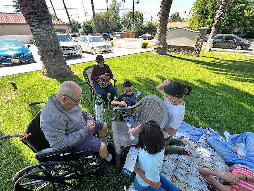A delightful family gathering in the park, enjoying a sunny day together.