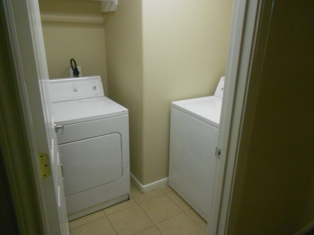 A compact laundry room featuring a washer and dryer.