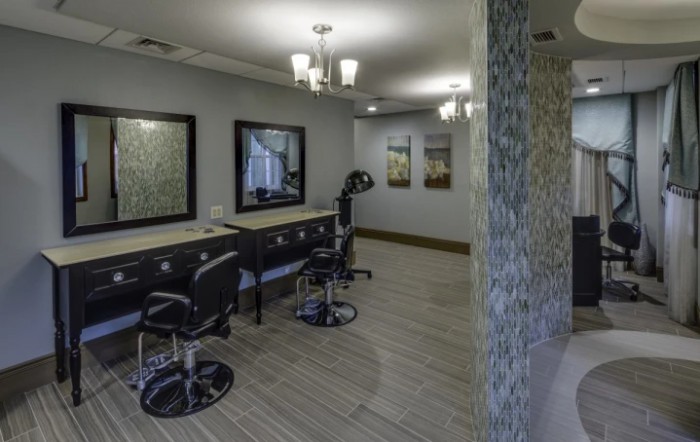 A modern salon interior with stylish chairs and mirrors.
