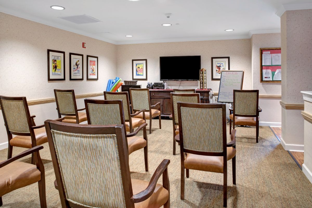 A conference room set up with chairs facing a television, ideal for meetings or seminars.